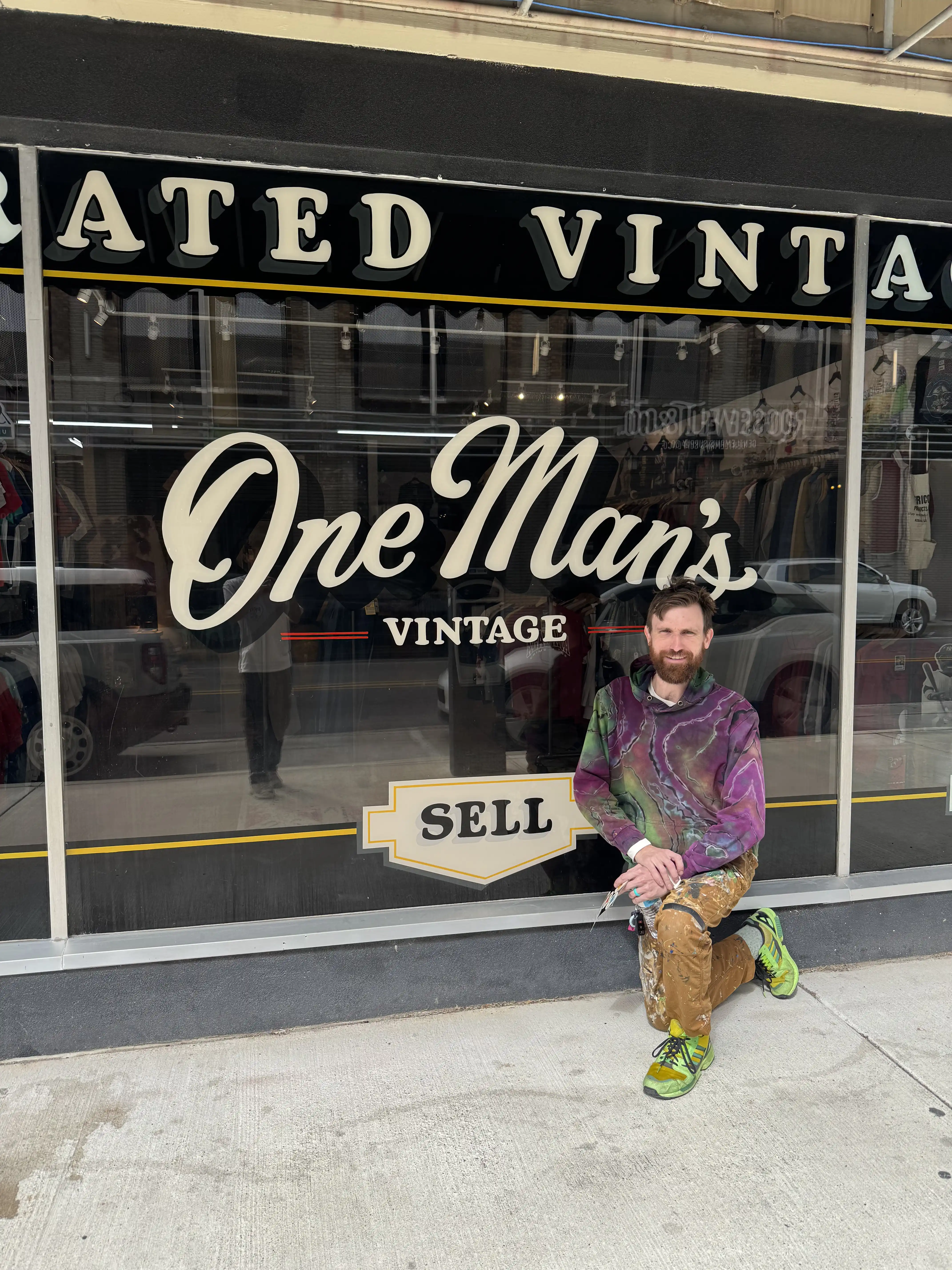 Creighton Tynes in front of One Man's Vintage window sign