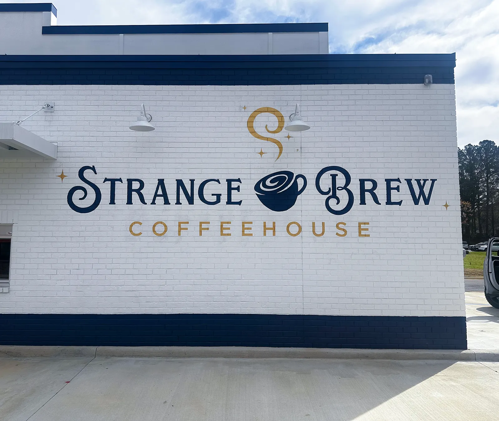 Hand-painted Strange Brew Coffeehouse wall sign in Northport, Alabama